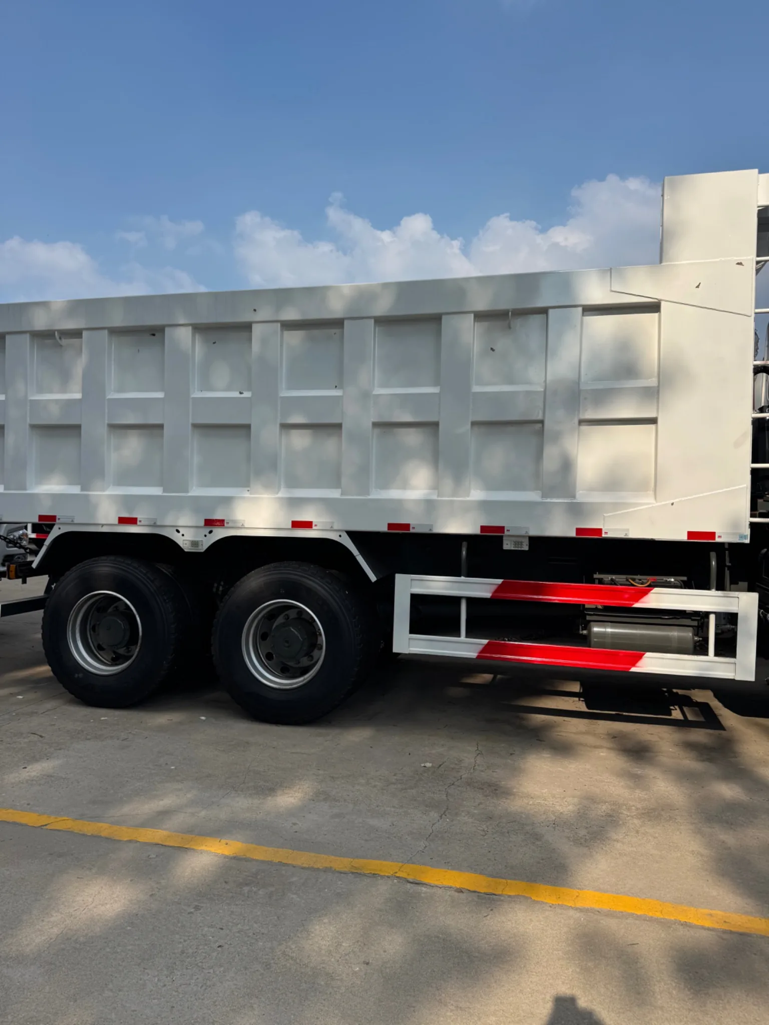 Side view of dump body and rear axles